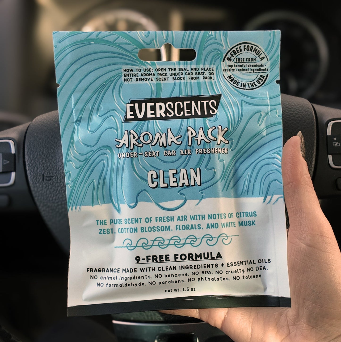 Everscents Aroma Pack Clean held in front of a car dashboard